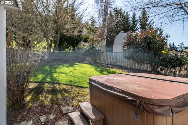 view of yard featuring a fenced backyard and a hot tub