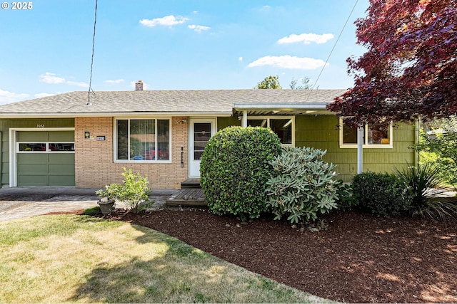 1052 Shamrock Dr SE, Salem, OR 97302 - ranch-style home featuring an attached garage, roof with shingles, a chimney, driveway, and brick siding