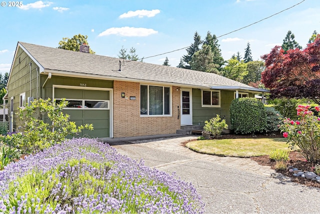 1052 Shamrock Dr SE, Salem, OR 97302 - ranch-style home featuring an attached garage, a chimney, driveway, brick siding, and roof with shingles