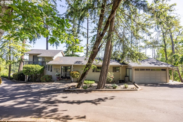 3484634844 Matthews Rd, Eugene, OR 97405 - split level home featuring asphalt driveway, an attached garage, and roof with shingles