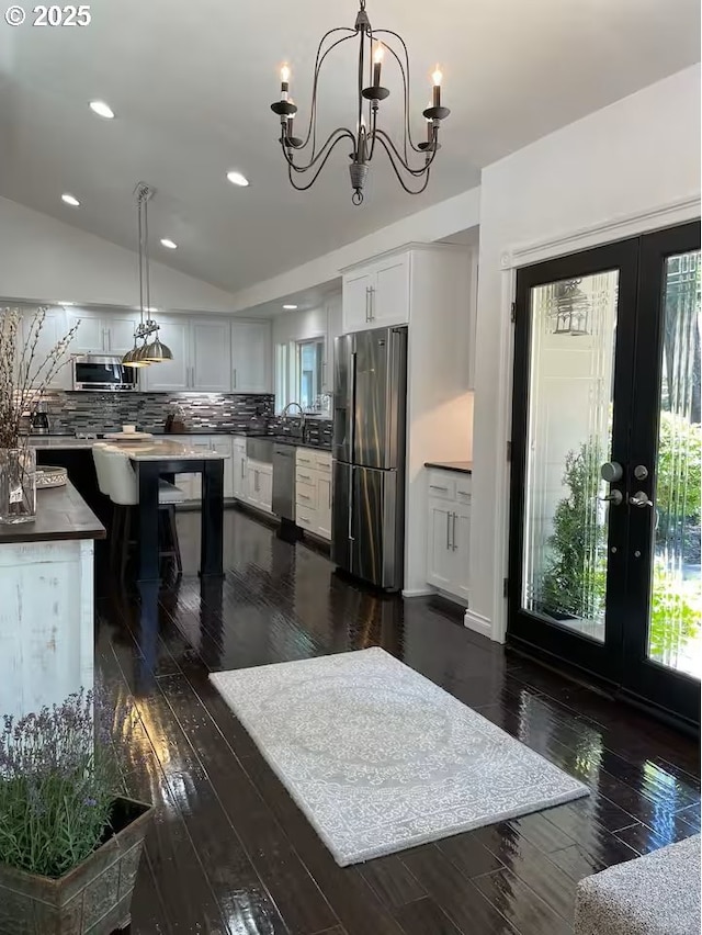 3484634844 Matthews Rd, Eugene, OR 97405 - kitchen with appliances with stainless steel finishes, white cabinets, dark wood-type flooring, tasteful backsplash, and recessed lighting