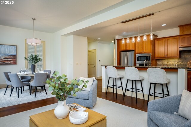 living room with recessed lighting and dark wood-style floors