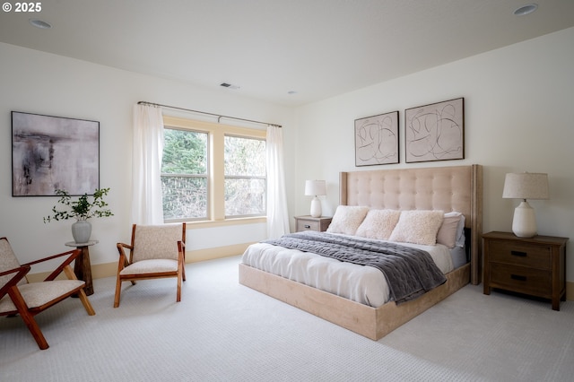 bedroom with visible vents and carpet