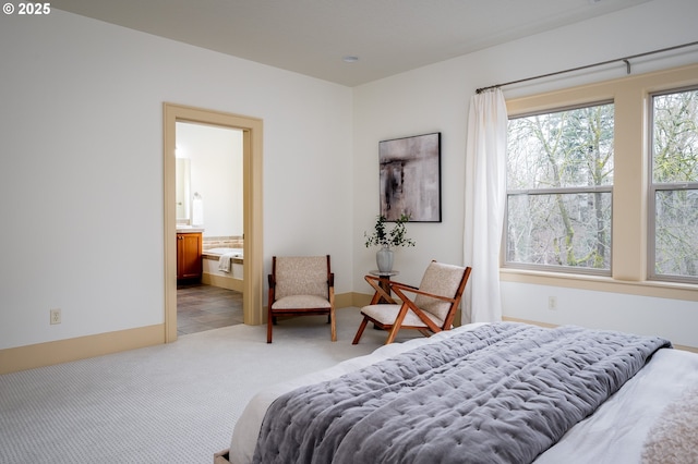carpeted bedroom featuring connected bathroom and tile patterned flooring