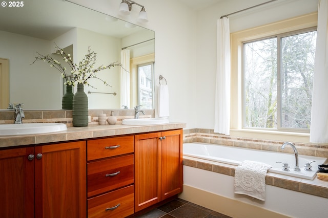 full bathroom featuring a sink, double vanity, and a wealth of natural light