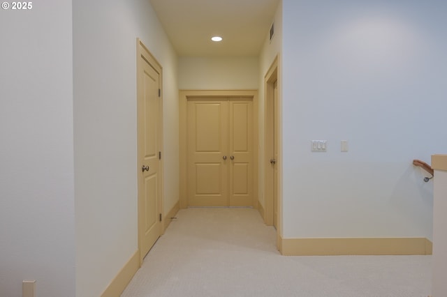 hallway with recessed lighting, baseboards, visible vents, and light carpet