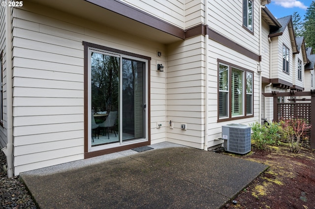 property entrance featuring a patio area and cooling unit