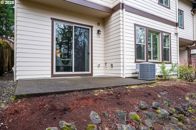 view of exterior entry featuring central AC unit