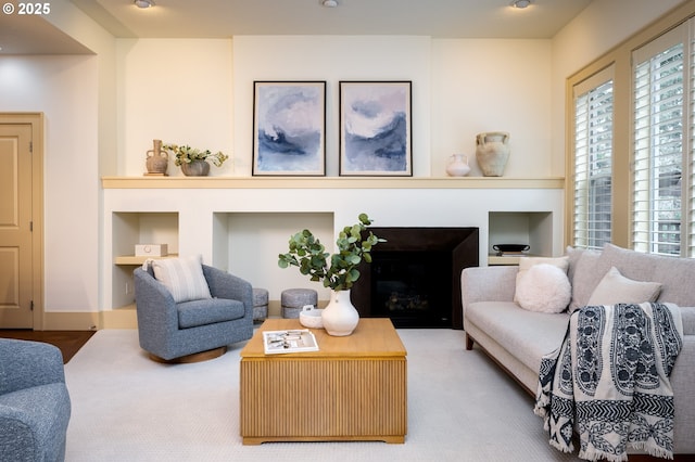 carpeted living room featuring built in features and a wealth of natural light