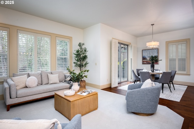 living area featuring baseboards and wood finished floors