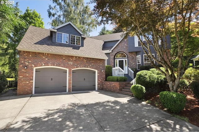 3840 NW Loy Ct, Portland, OR 97229 - view of front of home with concrete driveway, brick siding, a garage, and roof with shingles