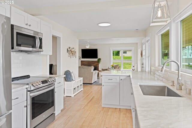 1331 NE Dallas St, Camas, WA 98607 - kitchen featuring stainless steel appliances, a sink, decorative backsplash, and open floor plan
