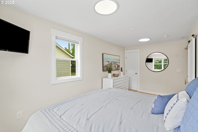 1331 NE Dallas St, Camas, WA 98607 - bedroom featuring a barn door and baseboards