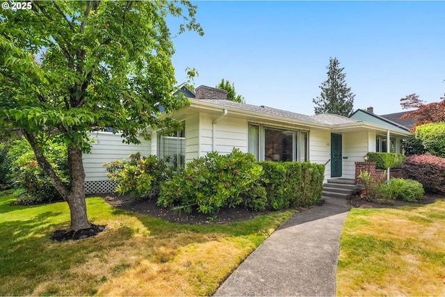 1134 NE Cesar E Chavez Blvd, Portland, OR 97232 - view of front facade with a front yard and a chimney