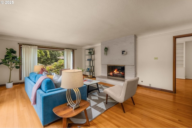 1134 NE Cesar E Chavez Blvd, Portland, OR 97232 - living area with a brick fireplace and light wood finished floors