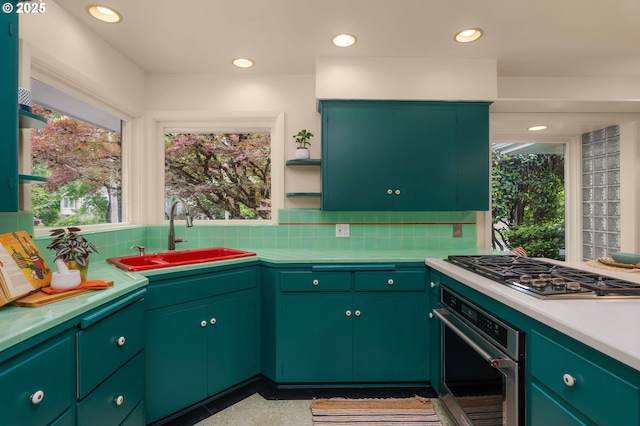 1134 NE Cesar E Chavez Blvd, Portland, OR 97232 - kitchen featuring stainless steel appliances, open shelves, backsplash, light countertops, and recessed lighting
