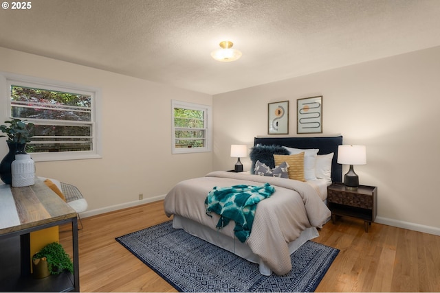1134 NE Cesar E Chavez Blvd, Portland, OR 97232 - bedroom with wood finished floors and a textured ceiling