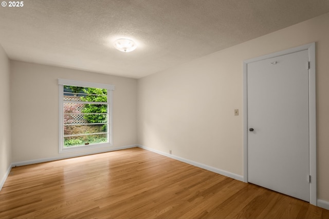 1134 NE Cesar E Chavez Blvd, Portland, OR 97232 - spare room with wood finished floors and a textured ceiling