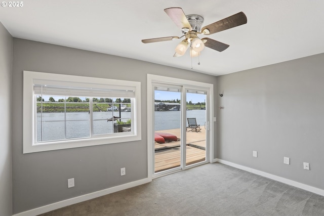 1879 N Jantzen Ave, Portland, OR 97217 - spare room featuring carpet floors, baseboards, ceiling fan, and a water view