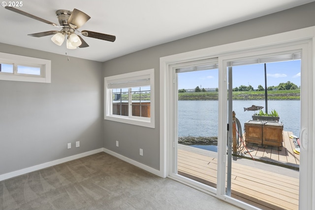 1879 N Jantzen Ave, Portland, OR 97217 - doorway to outside with a water view, baseboards, carpet floors, and a ceiling fan