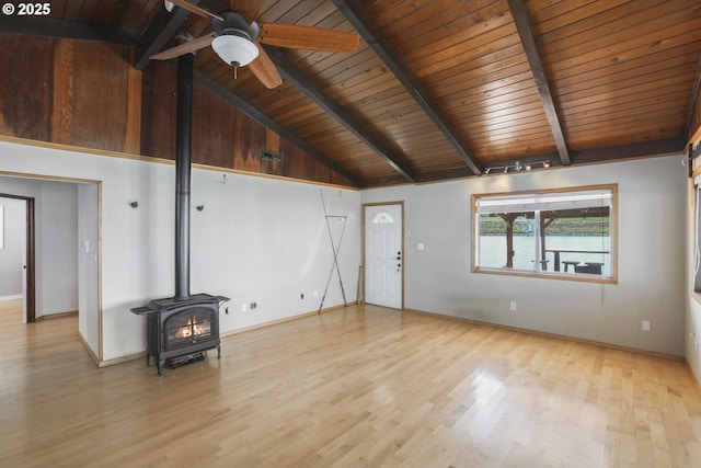 1879 N Jantzen Ave, Portland, OR 97217 - unfurnished living room with a wood stove, wooden ceiling with exposed beams, wood finished floors, ceiling fan, and baseboards