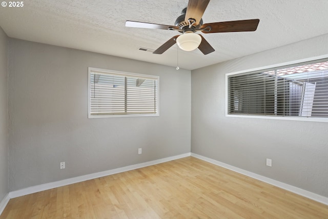 1879 N Jantzen Ave, Portland, OR 97217 - unfurnished room with wood finished floors, a ceiling fan, baseboards, and a textured ceiling