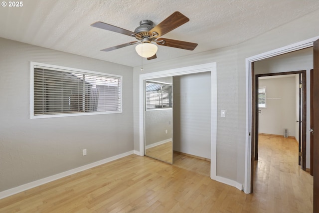 1879 N Jantzen Ave, Portland, OR 97217 - unfurnished bedroom featuring light wood finished floors, a closet, baseboards, a ceiling fan, and a textured ceiling