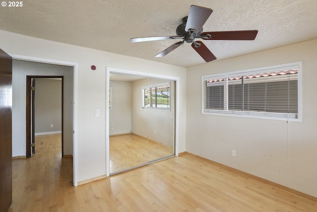 1879 N Jantzen Ave, Portland, OR 97217 - unfurnished bedroom featuring light wood-style flooring, a closet, baseboards, a textured ceiling, and a ceiling fan