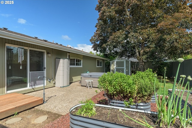 1740 Linnea Ave, Eugene, OR 97401 - fenced backyard featuring a hot tub and a vegetable garden