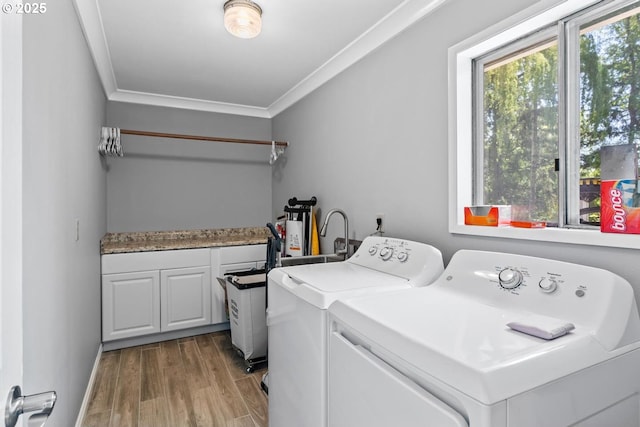 5944 SW Wilbard St, Portland, OR 97219 - laundry area featuring separate washer and dryer, crown molding, cabinet space, wood finished floors, and baseboards