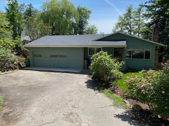 5944 SW Wilbard St, Portland, OR 97219 - ranch-style house with driveway, an attached garage, and a chimney