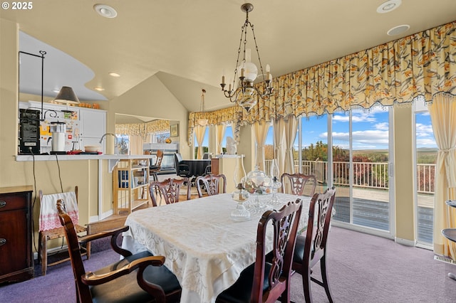 carpeted dining room featuring lofted ceiling