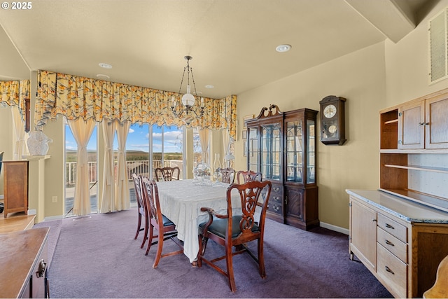 dining area featuring baseboards, dark colored carpet, visible vents, and a notable chandelier