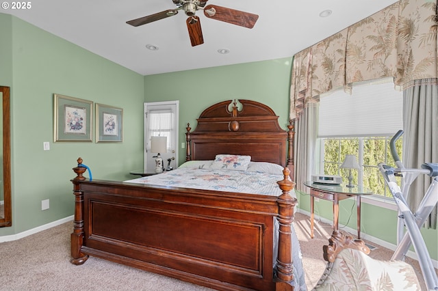 carpeted bedroom featuring a ceiling fan, baseboards, and multiple windows