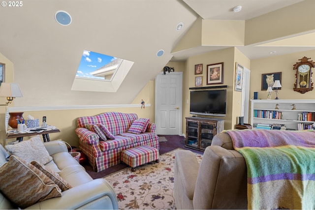 living area featuring vaulted ceiling with skylight and carpet