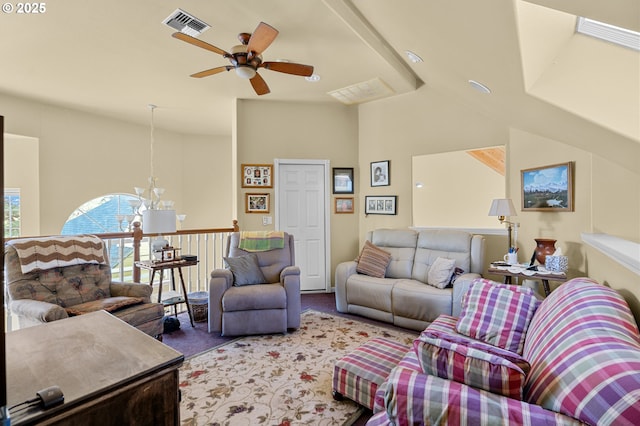 carpeted living area featuring visible vents, vaulted ceiling, and ceiling fan with notable chandelier