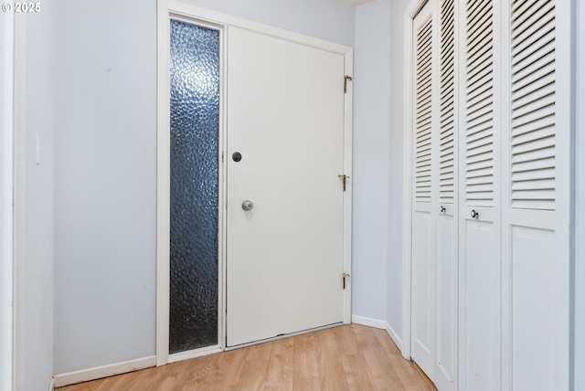 corridor with light hardwood / wood-style flooring