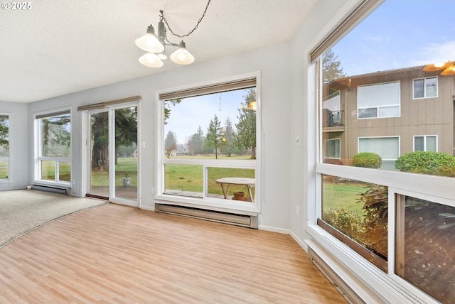 unfurnished sunroom featuring a chandelier and a baseboard radiator