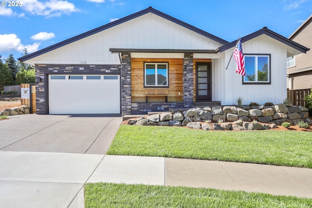 1236 Parkside Ave, Forest Grove, OR 97116 - view of front of property featuring stone siding, concrete driveway, a front yard, a garage, and a porch
