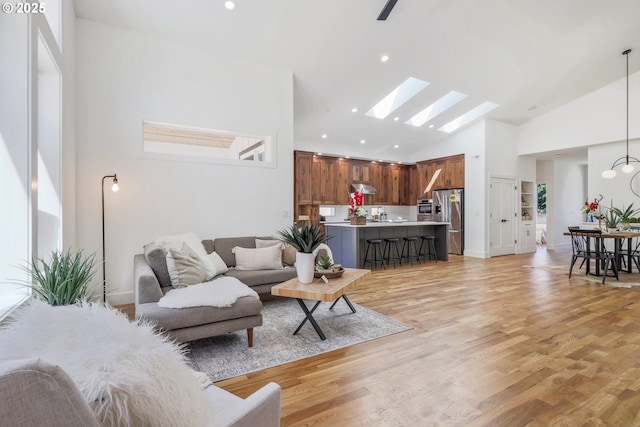 1236 Parkside Ave, Forest Grove, OR 97116 - living area featuring a skylight, high vaulted ceiling, light wood-style flooring, recessed lighting, and baseboards
