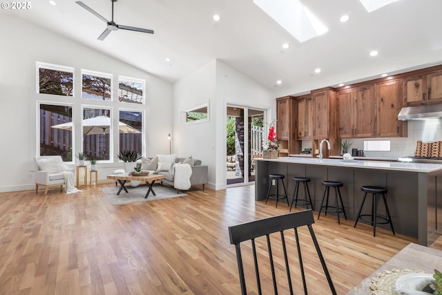1236 Parkside Ave, Forest Grove, OR 97116 - living room with high vaulted ceiling, light wood-type flooring, recessed lighting, a skylight, and baseboards
