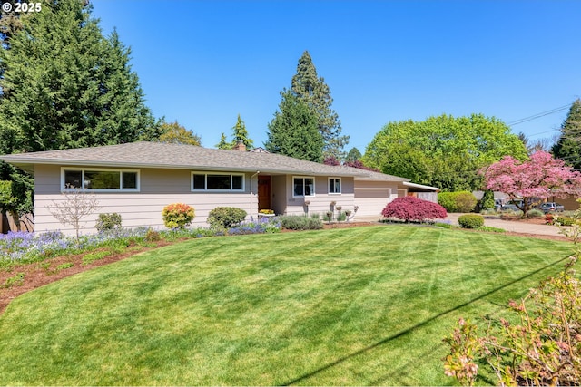 ranch-style home featuring an attached garage, a chimney, and a front lawn