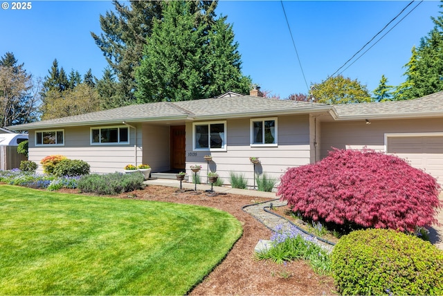 single story home featuring a front lawn, an attached garage, roof with shingles, and a chimney