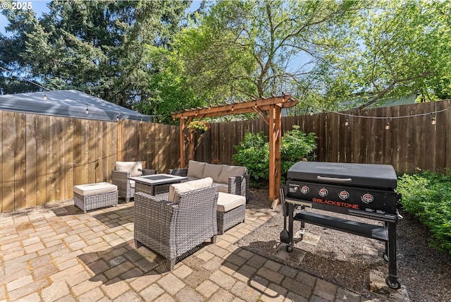 4952 SW Wentworth Ter, Beaverton, OR 97078 - view of patio featuring a fenced backyard, area for grilling, and an outdoor living space with a fire pit