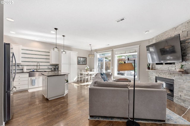 4952 SW Wentworth Ter, Beaverton, OR 97078 - living area featuring a fireplace, dark wood-type flooring, and recessed lighting