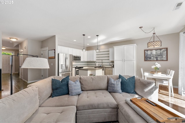 4952 SW Wentworth Ter, Beaverton, OR 97078 - living room with wood finished floors, baseboards, and recessed lighting