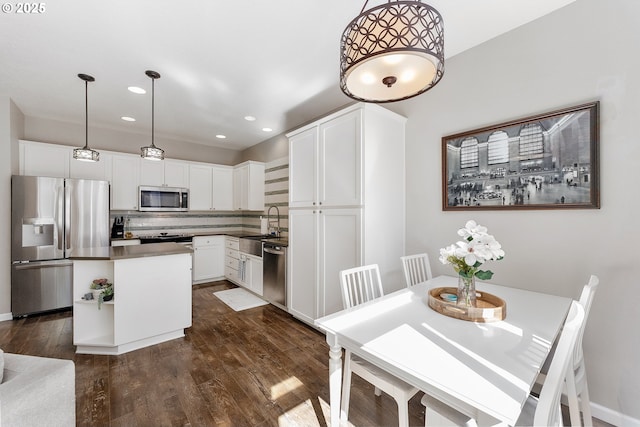 4952 SW Wentworth Ter, Beaverton, OR 97078 - dining room featuring dark wood-style flooring and recessed lighting