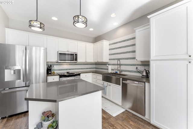 4952 SW Wentworth Ter, Beaverton, OR 97078 - kitchen featuring stainless steel appliances, a sink, dark countertops, backsplash, and recessed lighting