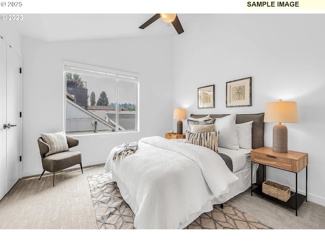 carpeted bedroom with vaulted ceiling and ceiling fan