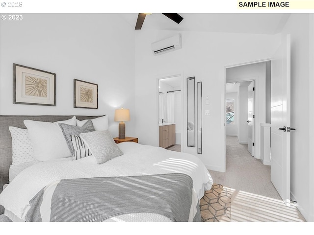 bedroom featuring connected bathroom, light colored carpet, an AC wall unit, and high vaulted ceiling